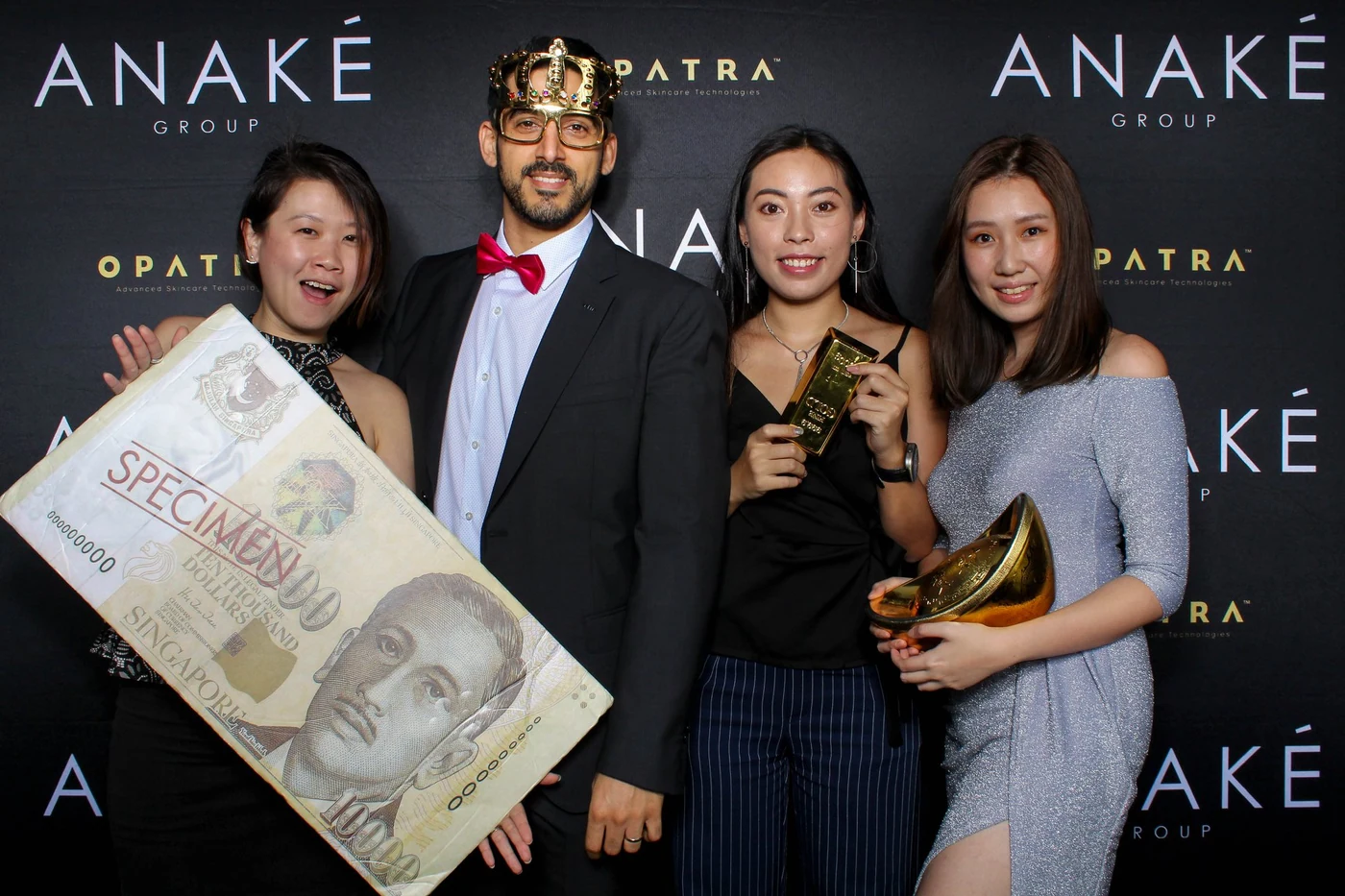 Guests posing with a branded printed backdrop