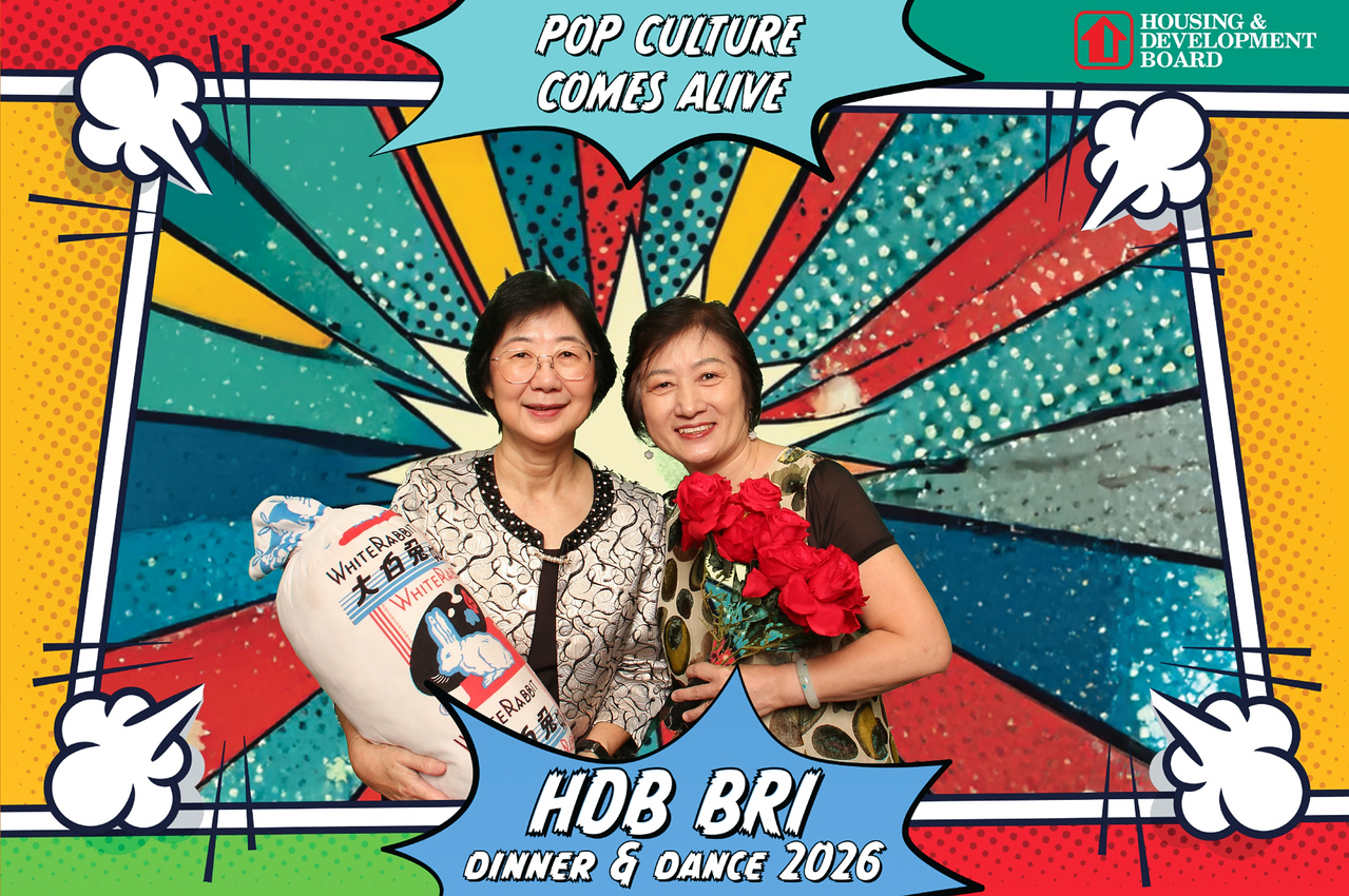 Two HDB BRI 2026 guests posing in a colourful pop-art photo booth print